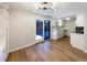 Open concept dining area with kitchen access and wood flooring at 1772 Robb St, Lakewood, CO 80215