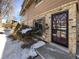 Front entrance of the townhome with brick facade and landscaping at 1772 Robb St, Lakewood, CO 80215