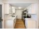 Remodeled kitchen features white cabinets, stainless steel appliances, and quartz countertops at 1772 Robb St, Lakewood, CO 80215