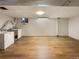 Unfinished basement laundry area with vinyl flooring at 1772 Robb St, Lakewood, CO 80215