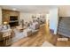 Virtually staged living room featuring a fireplace and hardwood floors at 1772 Robb St, Lakewood, CO 80215