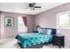Cozy bedroom features a ceiling fan, two windows and comfortable looking bed at 11502 W 101St Avenue, Westminster, CO 80021