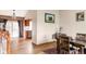 Open-concept dining room with hardwood floors and view to the kitchen and sliding glass door at 11502 W 101St Avenue, Westminster, CO 80021