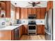 Modern kitchen with stainless steel appliances, white subway tile backsplash, and wood cabinets at 11502 W 101St Avenue, Westminster, CO 80021