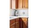 Close-up of kitchen counter with an espresso maker, white backsplash and wooden cabinets at 11502 W 101St Avenue, Westminster, CO 80021