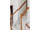 Carpeted staircase with wooden banister and white spindles leading to the upper level at 11502 W 101St Avenue, Westminster, CO 80021
