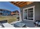 Inviting back patio with wicker furniture and a grill, perfect for outdoor entertaining at 3953 John Ave, Castle Rock, CO 80104