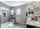 Modern bathroom featuring a glass shower with a built-in bench and a granite-topped vanity at 3953 John Ave, Castle Rock, CO 80104