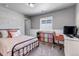 Comfortable bedroom with bed, desk, and window with blinds at 3953 John Ave, Castle Rock, CO 80104