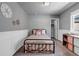 Cozy bedroom featuring a bed, wainscoting, and neutral decor at 3953 John Ave, Castle Rock, CO 80104