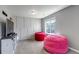 Bright bonus room with comfy beanbag chairs, modern wall decor, and natural light from a window at 3953 John Ave, Castle Rock, CO 80104