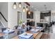 Open concept dining area with modern lighting, table setting and view into the kitchen at 3953 John Ave, Castle Rock, CO 80104