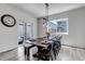 Dining room with modern table and chairs, featuring a large window and sliding door at 3953 John Ave, Castle Rock, CO 80104
