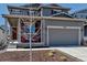 Charming two-story home with a well-manicured front yard and inviting front porch, perfect for relaxing outdoors at 3953 John Ave, Castle Rock, CO 80104