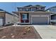 Charming two-story home with a well-manicured front yard and inviting front porch, perfect for relaxing outdoors at 3953 John Ave, Castle Rock, CO 80104