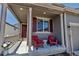 Inviting front porch with comfortable seating, perfect for enjoying the outdoors at 3953 John Ave, Castle Rock, CO 80104