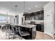 Stylish kitchen with dark cabinetry and a large island with bar stool seating at 3953 John Ave, Castle Rock, CO 80104