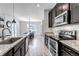 Open kitchen with granite counters, stainless appliances, and breakfast bar at 3953 John Ave, Castle Rock, CO 80104