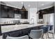 Modern kitchen featuring an island with seating and stainless steel appliances at 3953 John Ave, Castle Rock, CO 80104