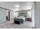 Serene main bedroom with a calming color palette, stylish barn door, and ample natural light at 3953 John Ave, Castle Rock, CO 80104