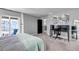Large primary suite with a desk/office area, and a sliding glass door to access the balcony at 3953 John Ave, Castle Rock, CO 80104