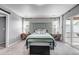 Tranquil main bedroom features a decorative headboard, soft carpet, and access to a private balcony at 3953 John Ave, Castle Rock, CO 80104