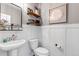 Stylish powder room with pedestal sink, modern fixtures, and decorative wall art at 3953 John Ave, Castle Rock, CO 80104