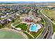Community aerial view showcasing a pool, clubhouse, and surrounding residential area at 652 Pinecliff Dr, Erie, CO 80516
