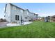 Private backyard with a patio, green lawn, and play set, perfect for outdoor entertaining and relaxation at 652 Pinecliff Dr, Erie, CO 80516