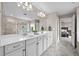 Bathroom featuring a double vanity, quartz counters, and a separate glass-enclosed shower at 652 Pinecliff Dr, Erie, CO 80516