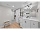 Elegant bathroom with a white vanity, modern fixtures, and stylish wood-look floors at 652 Pinecliff Dr, Erie, CO 80516
