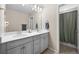 Bathroom featuring double sinks with modern countertops, and shower with curtain at 652 Pinecliff Dr, Erie, CO 80516