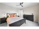 Well-lit bedroom with warm accents, a ceiling fan, and generous closet space at 652 Pinecliff Dr, Erie, CO 80516