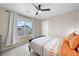 Comfortable bedroom with natural light, neutral walls, and an overhead fan at 652 Pinecliff Dr, Erie, CO 80516