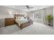 Cozy bedroom with a ceiling fan, plush carpet, and natural light from a window at 652 Pinecliff Dr, Erie, CO 80516