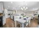 Open-concept floor plan featuring a dining area, kitchen island and spacious living room at 652 Pinecliff Dr, Erie, CO 80516