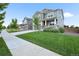 View of two-story home with well-manicured lawn and sidewalk leading to the front of the house at 652 Pinecliff Dr, Erie, CO 80516