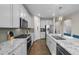 Contemporary kitchen with stainless steel appliances, granite countertops, and an island with a breakfast bar at 652 Pinecliff Dr, Erie, CO 80516
