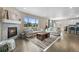Spacious living room with fireplace, hardwood floors, neutral furniture and large windows at 652 Pinecliff Dr, Erie, CO 80516