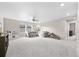 Large living room with plush carpet and neutral tones, perfect for entertaining at 652 Pinecliff Dr, Erie, CO 80516