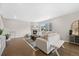Cozy living room with fireplace, hardwood floors, modern furniture and abundant natural light at 652 Pinecliff Dr, Erie, CO 80516