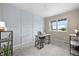 Bright home office with a light gray accent wall, plush carpet and window with a view at 652 Pinecliff Dr, Erie, CO 80516