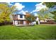 Spacious backyard featuring a lush lawn, a patio, mature trees and privacy fence at 4656 Tanglewood Trl, Boulder, CO 80301