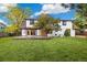Expansive backyard featuring a patio, lush lawn, privacy fence, and mature trees at 4656 Tanglewood Trl, Boulder, CO 80301