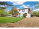 Well-maintained backyard with a patio, grass, mature trees, and a gravel side yard at 4656 Tanglewood Trl, Boulder, CO 80301