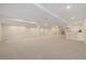 Spacious carpeted basement with white columns, recessed lighting, and wet bar area at 4656 Tanglewood Trl, Boulder, CO 80301