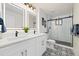 Modern bathroom features a dual sink vanity with sleek black fixtures and a glass-enclosed shower at 4656 Tanglewood Trl, Boulder, CO 80301