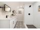 This renovated bathroom includes dual sinks, a tiled shower, and modern black fixtures at 4656 Tanglewood Trl, Boulder, CO 80301