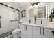 Bathroom with double sink vanity and walk-in shower featuring black fixtures and modern lighting at 4656 Tanglewood Trl, Boulder, CO 80301