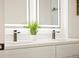 Bright bathroom featuring a double vanity, modern faucets, and decorative lighting at 4656 Tanglewood Trl, Boulder, CO 80301